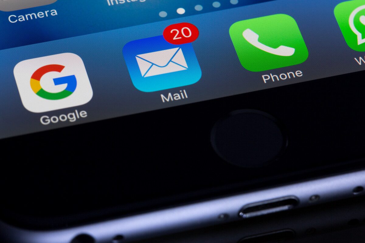 close-up smartphone screen showing email app icon with new message notification, used to illustrate Office 365 SMTP email issues