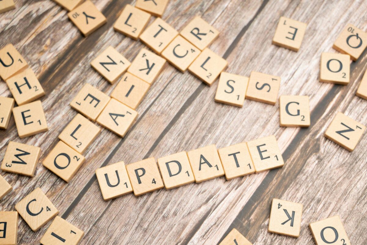 Scrabble tiles arranged on a wooden surface spelling the word UPDATE, representing resetting file versions in SharePoint with ShareMaster.